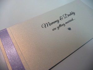 Lilac and ivory cheque book invitation with mummy and daddy are getting married wording