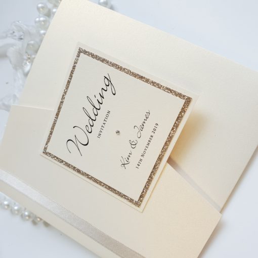 Ivory and Gold Glitter themed Pocketfold wedding invitations with ivory ribbon