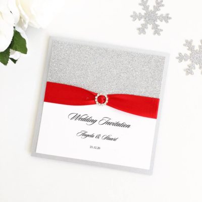 Silver Glitter themed Wedding Invitations with red ribbon and a fancy diamante buckle