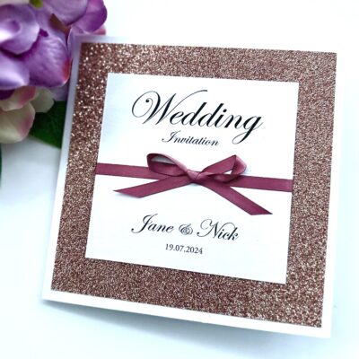 Rose gold Glitter folded wedding invitation with a bow detail