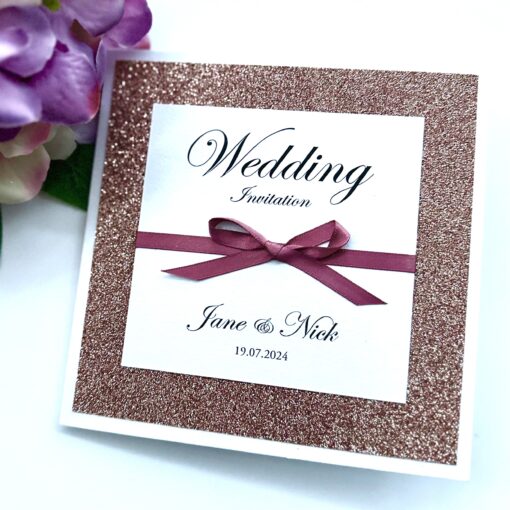 Rose gold Glitter folded wedding invitation with a bow detail