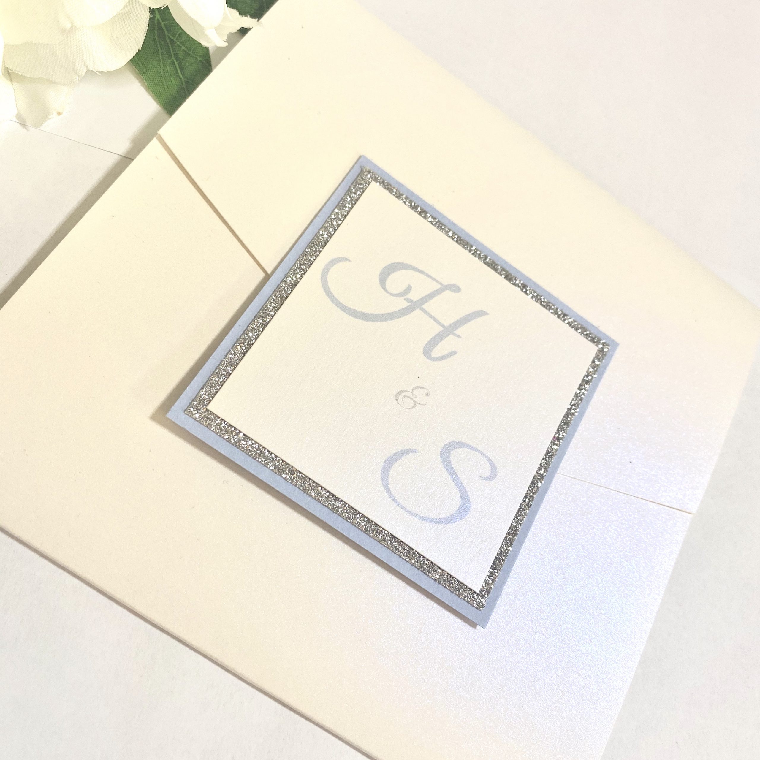 Crisp white pocketfold invitation with initials