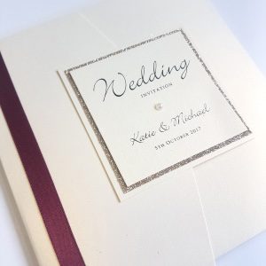 classic ivory pocketfold with burgundy ribbon and gold glitter