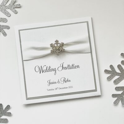 white and silver snowflake pocketfold with ribbon and buckle