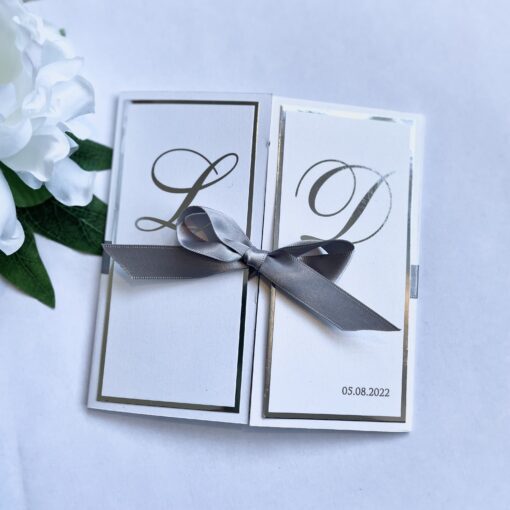 gatefold invitation with silver foiled monogram design