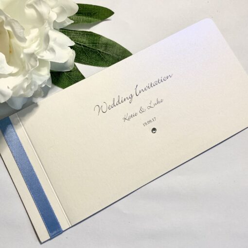 Classic white chequebook with blue ribbon and back