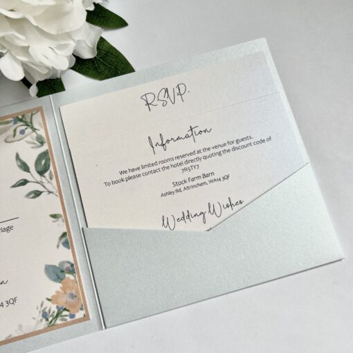 pretty pearlised pocketfold invitation wild flower wreath and peach ribbon