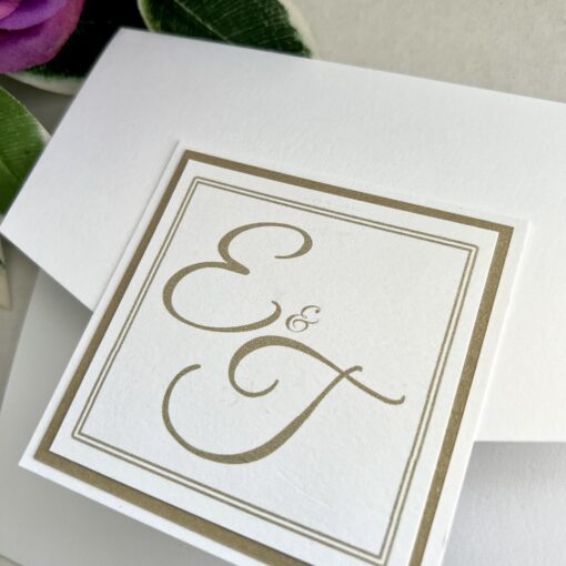 White and gold monogram pocketfold invitation