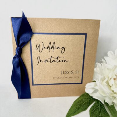 Kraft folded invitation with large navy bow