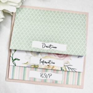 Three wedding invitations, one green, one striped, and one with prints of flowers