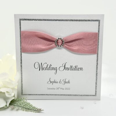 White Pearlised Pocketfold Wedding Invitation with Pink Ribbon and Diamante Buckle