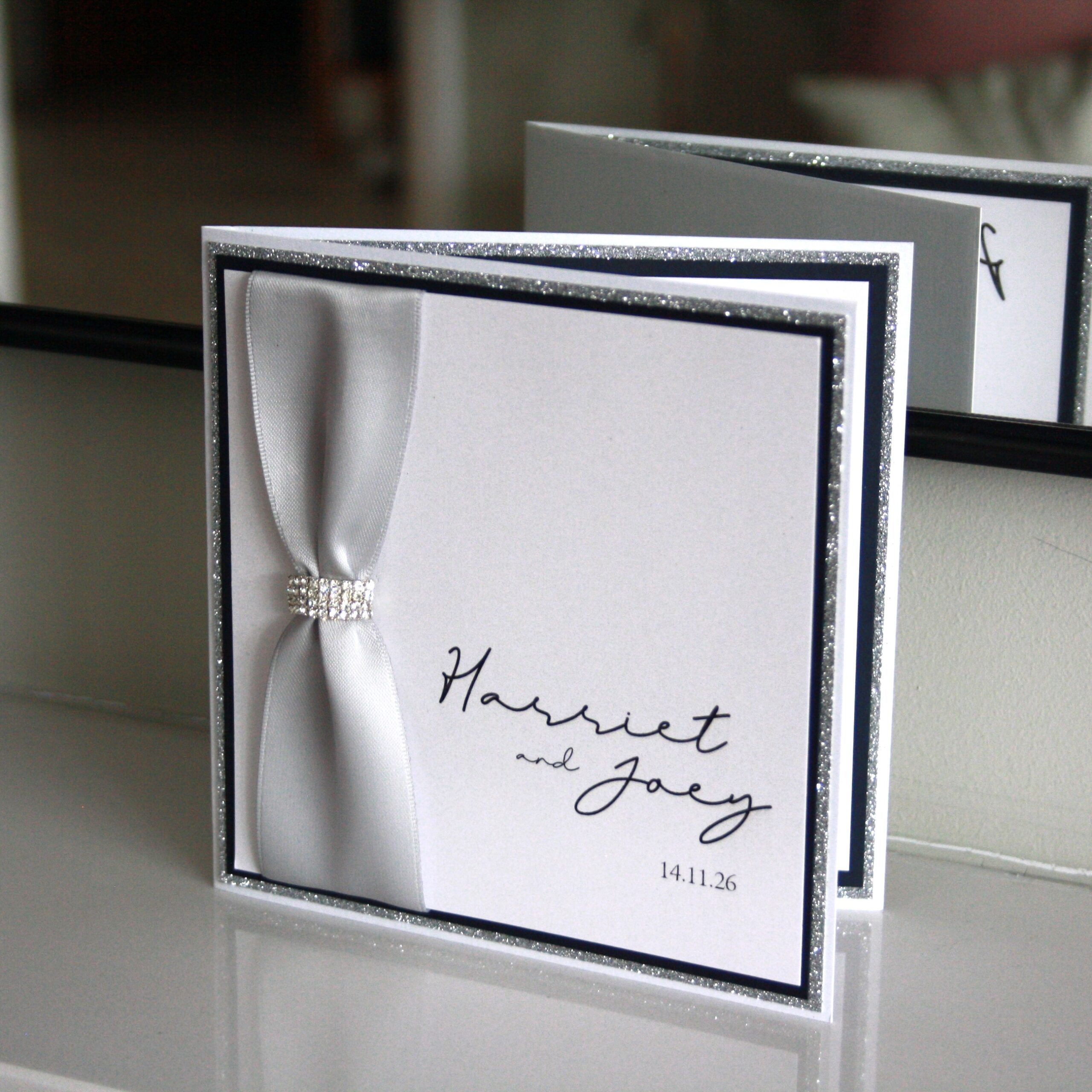 Luxury folded invitation with buckle detail.